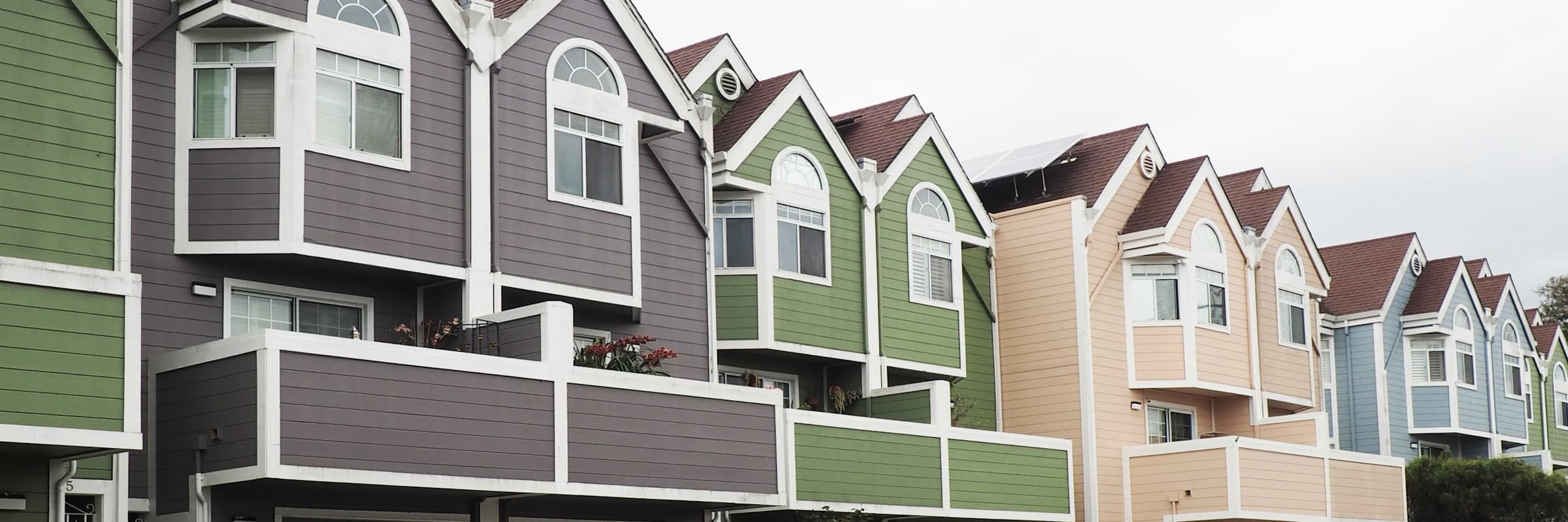 Illustrative row of townhomes with gabled roofs